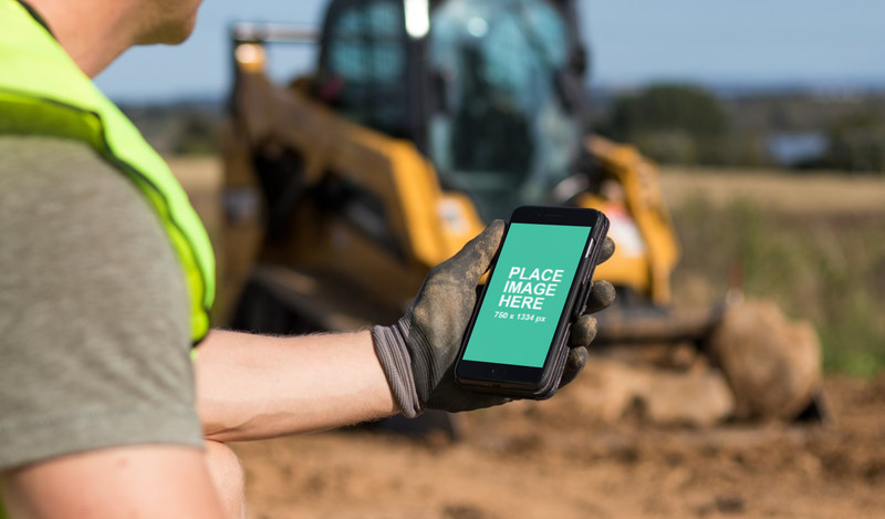 Construction worker looking at iPhone 8