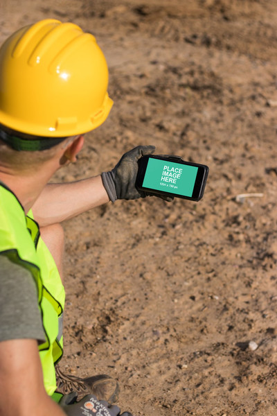 Construction worker holding iPhone