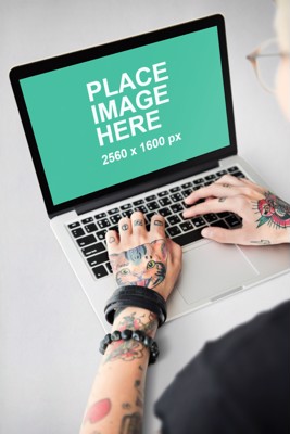 Tattooed woman using MacBook
