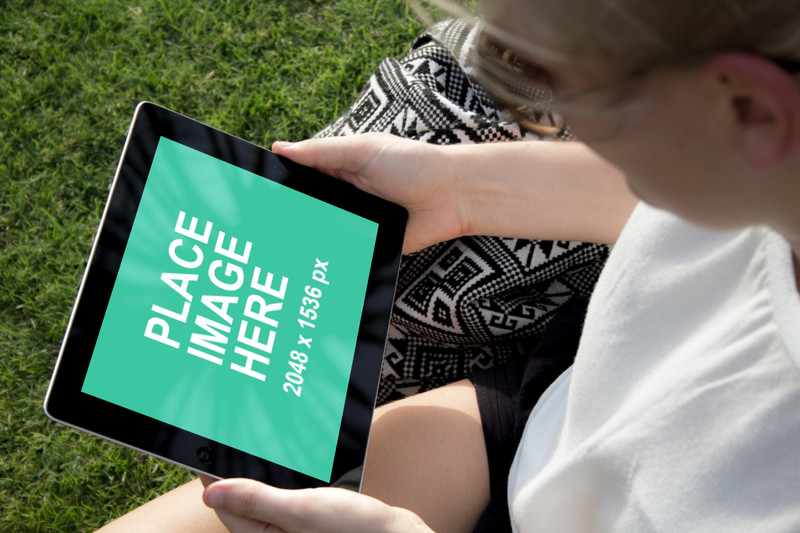 Black iPad 4 landscape mode on grass