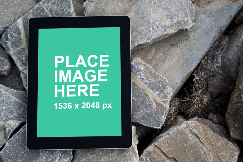 Black iPad 4 on rocks with front view