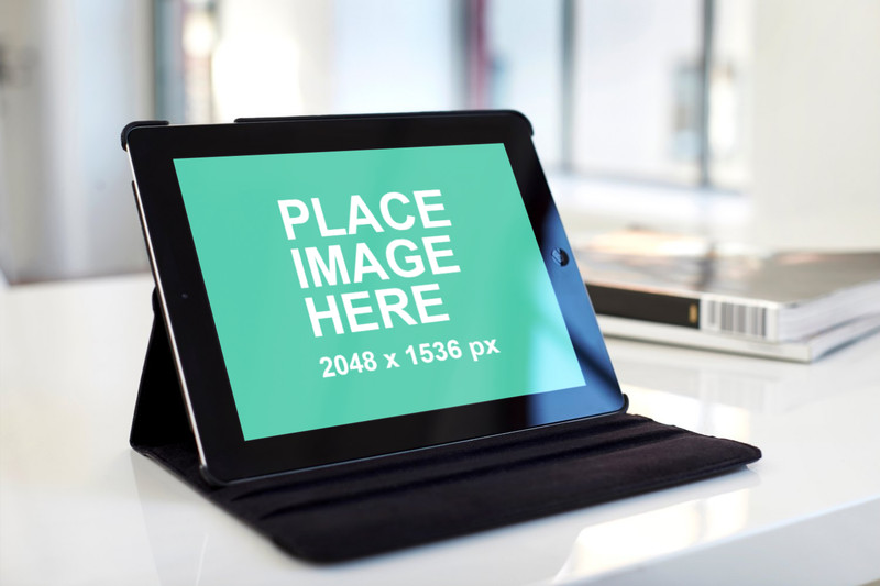 Black iPad in cover on table