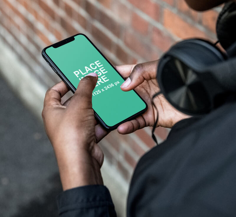 Closeup of man holding iPhone X