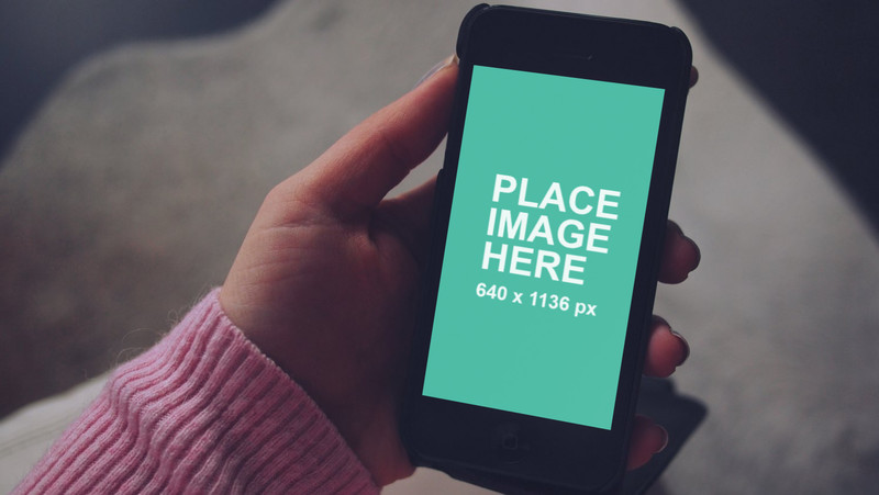 Woman holding black iPhone