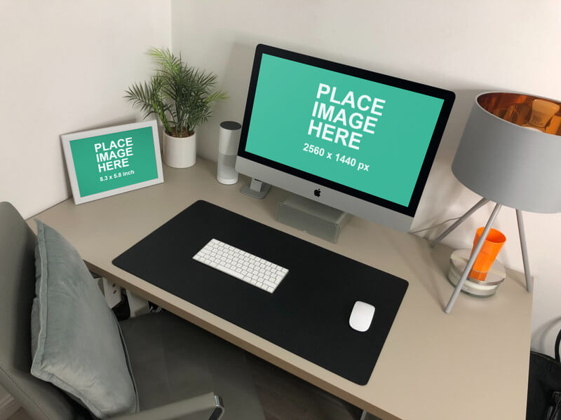 iMac and small white frame on desk