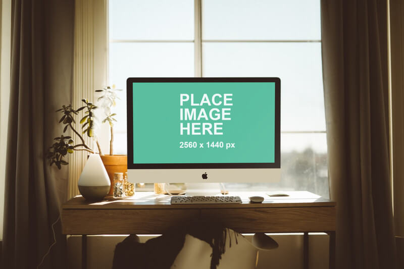 iMac on natural wood desk