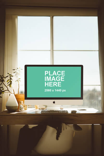 iMac on wood desk with natural light