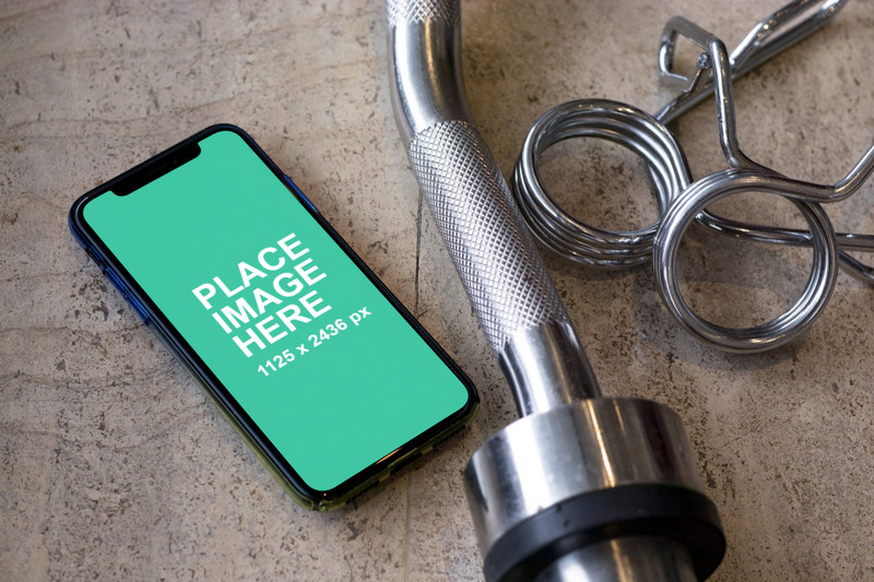 iPhone X with gym equipment