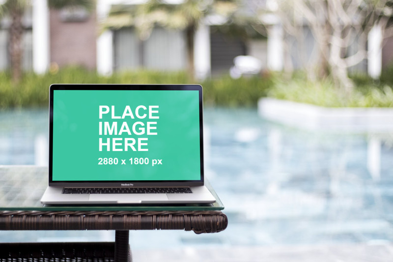 Macbook Pro with pool in background