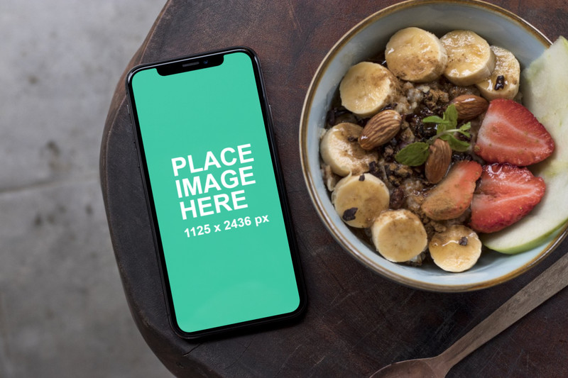 iPhone X with fruit bowl