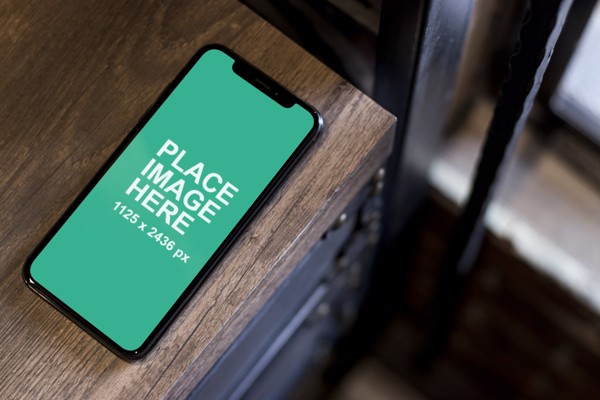 iPhone X laying on shelf