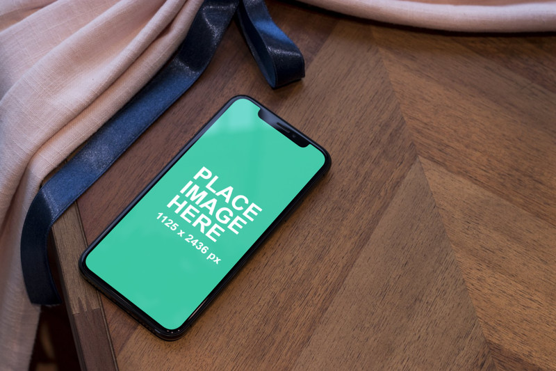 iPhone X on wooden table