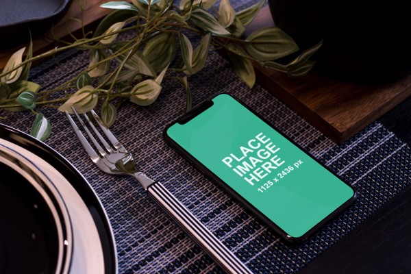 iPhone X on dinner table