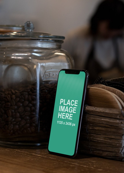 iPhone X standing on table