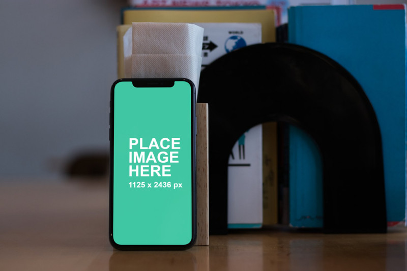 iPhone X standing on wooden table
