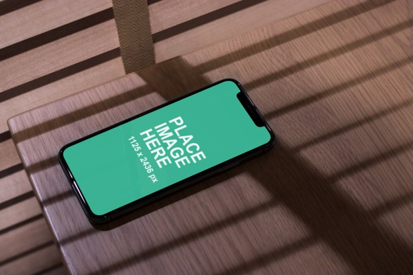 iPhone X on wooden table
