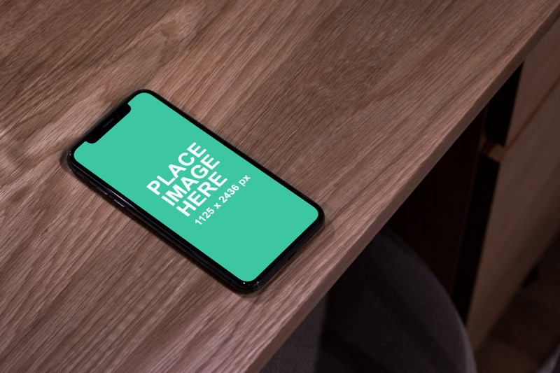 iPhone laying on wooden table