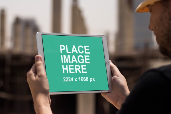 Construction worker holding iPad pro