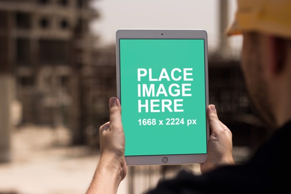 Construction man holding iPad pro