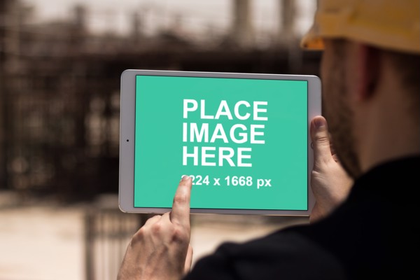 Construction man holding iPad pro