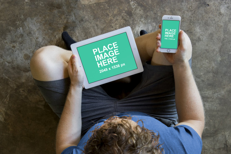 Man sitting with iPad and iPhone