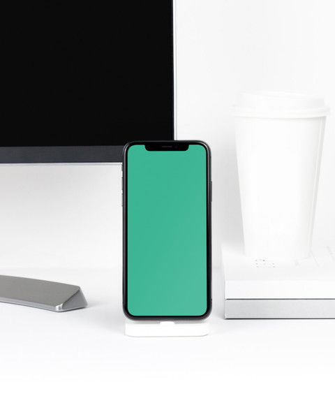 iPhone X on white desk