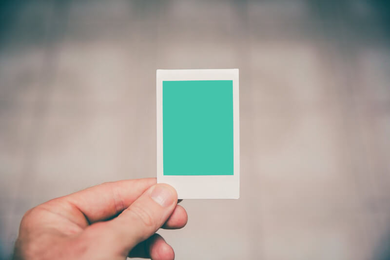 Man holding instant photo