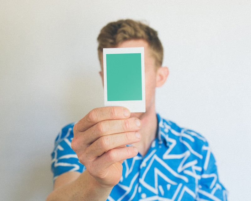 Man holding instant photo