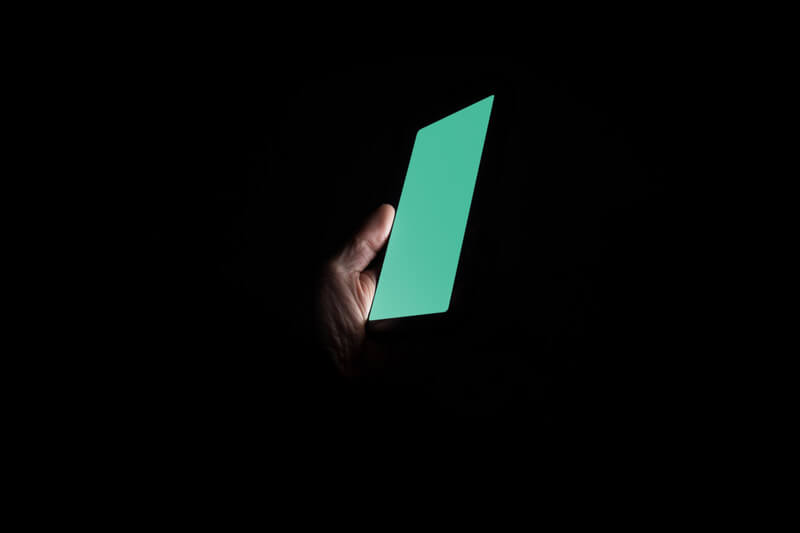 Man holding Samsung Galaxy at night