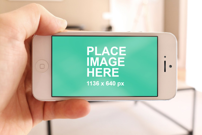 Man holding white iPhone 5