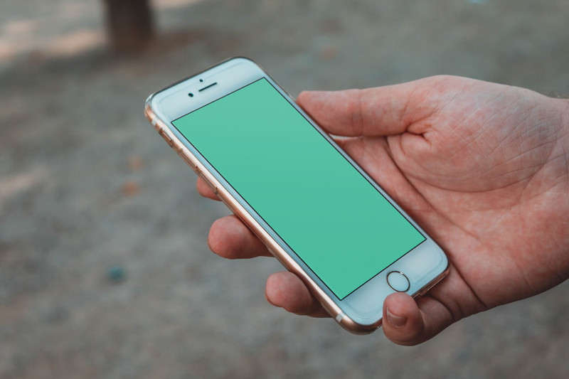 Man holding white iPhone