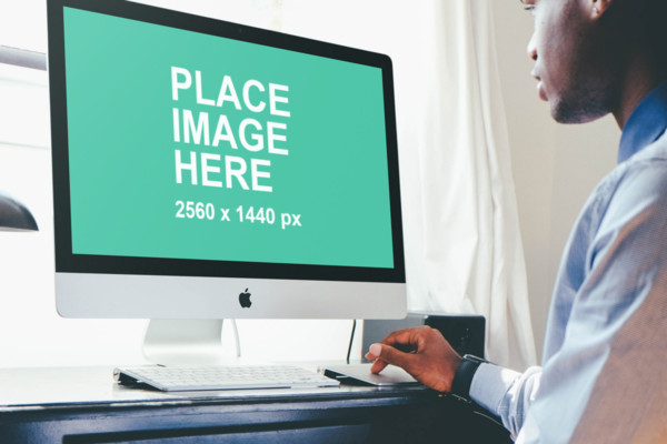 Man looking at iMac