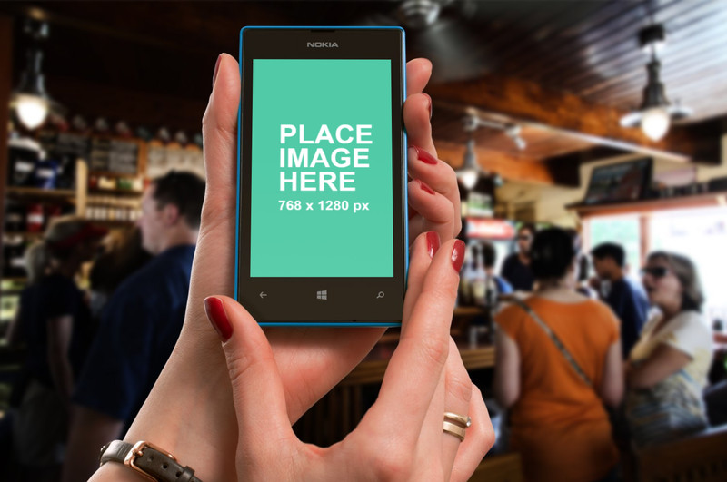 Woman holding Nokia Lumia at bar