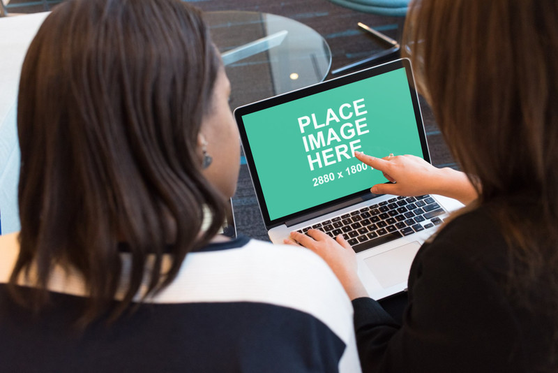 Two woman working on laptop