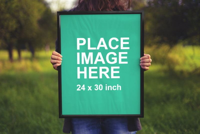 Woman holding black frame