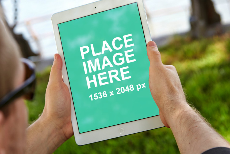 White iPad Air in a park