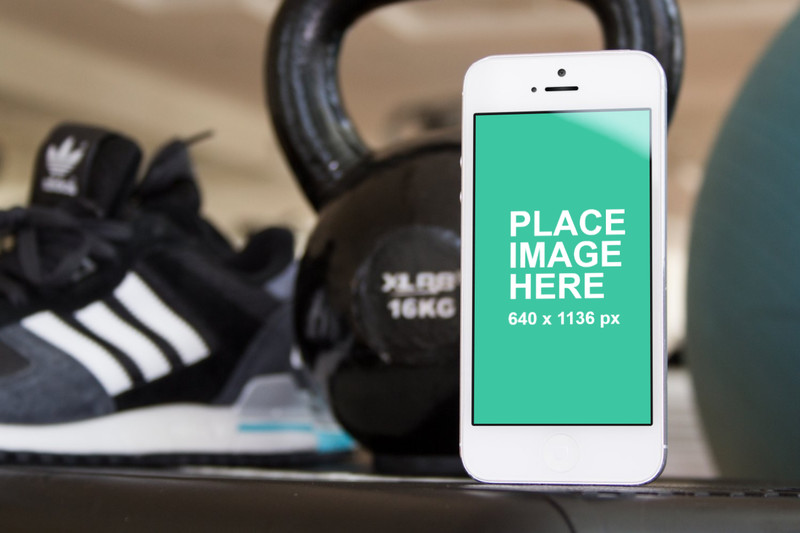 White iPhone 5 on gym floor