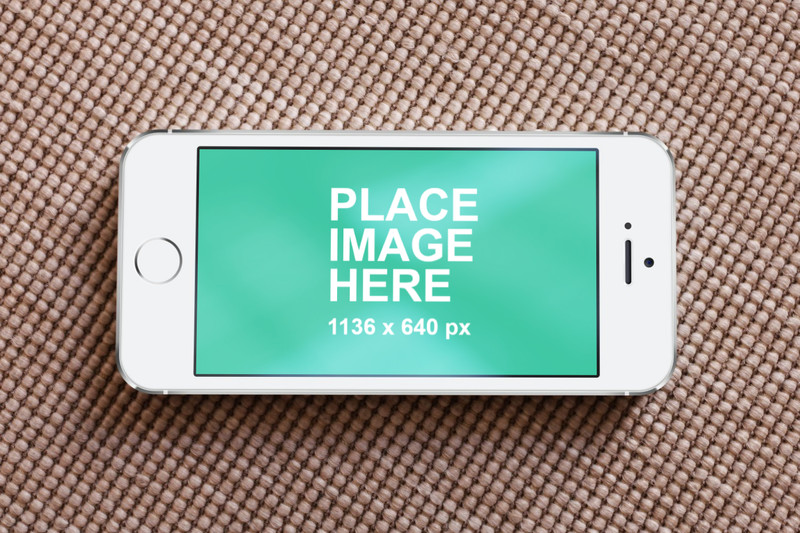 White iPhone 5 on rug