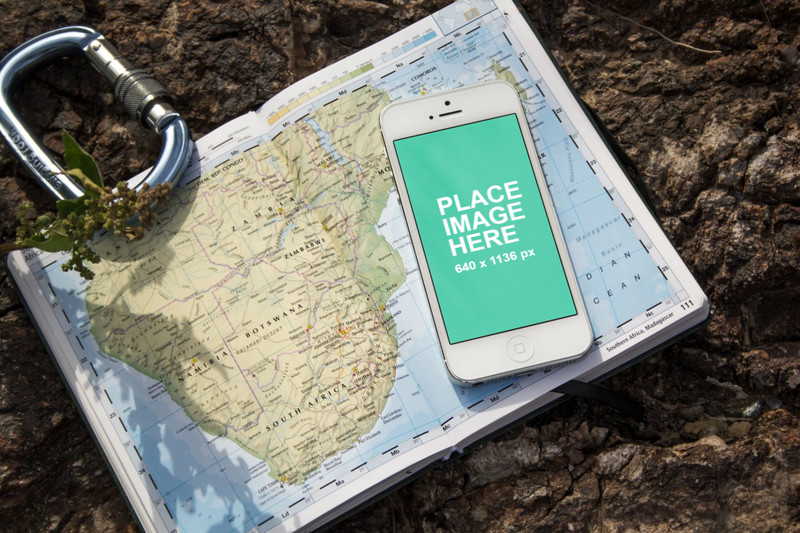 White iPhone 5 outside on world map