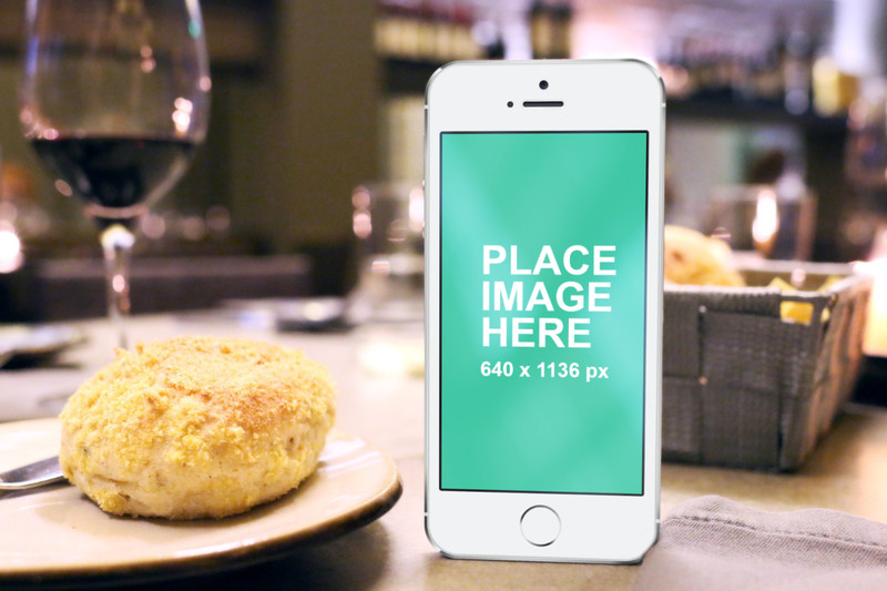 White iPhone 5 with bread and wine
