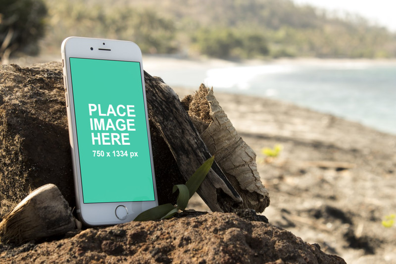 White iPhone 6 on beach