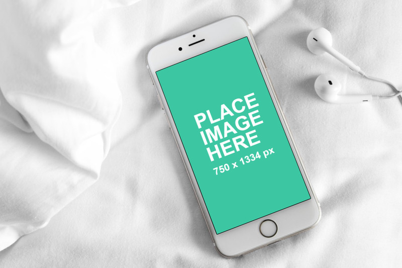 White iPhone 6 on sheets