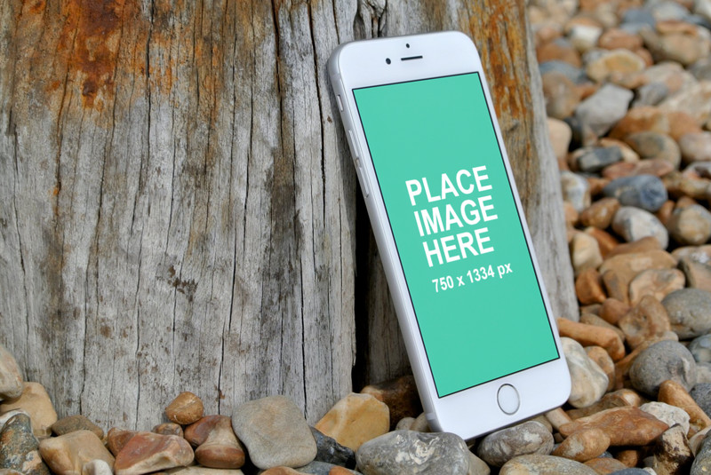 White iPhone 6 on stones