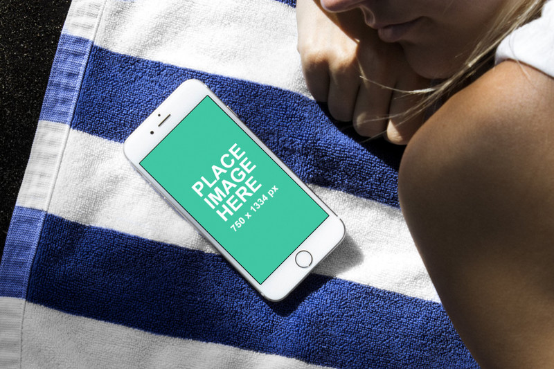 White iPhone on towel with woman