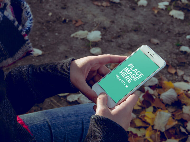 Woman holding iPhone 7 outdoors