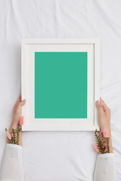 Woman holding white frame