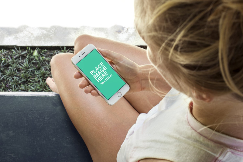 Woman holding white iPhone 6