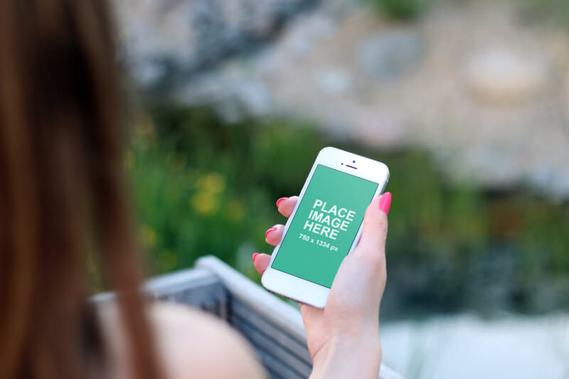 Woman holding white iPhone 6