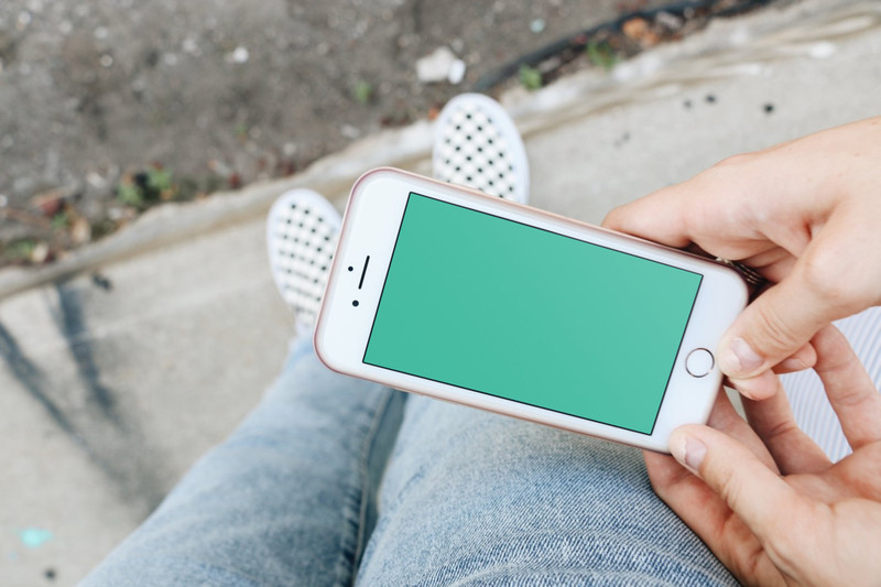 Woman holding white iPhone