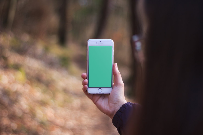 Woman holding white iPhone